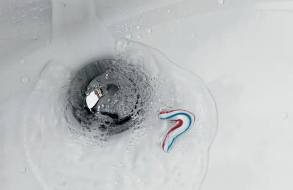 bathroom-sink-white-water-flows-down-the-drain-570x370