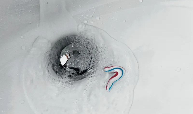 bathroom-sink-white-water-flows-down-the-drain